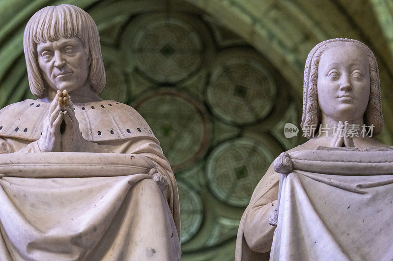 法国巴黎圣丹尼斯大教堂展出的以祈祷姿态展示的法国统治者大理石雕像近照。头发，衣服的细节