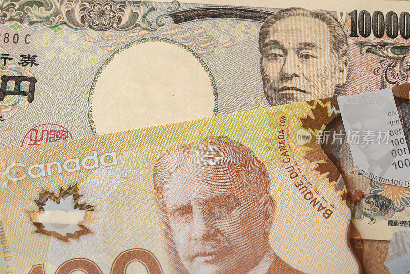 加拿大100加元和日本10000日元钞票特写-货币兑换