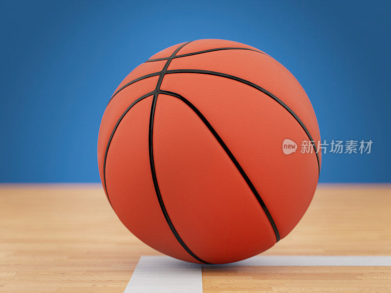 木质拼花地板上的橙色篮球