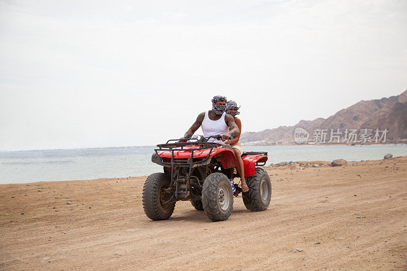在沙漠中乘坐亚视的游客，在埃及沙姆沙伊赫驾驶四轮摩托车的人们