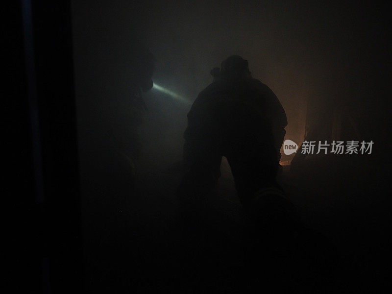 在烟雾中爬行的消防员