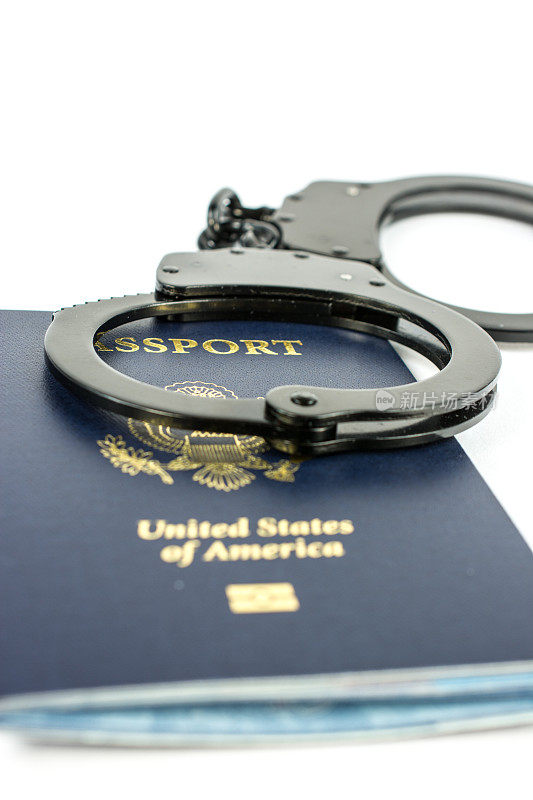 美国护照和手铐在浅色背景上