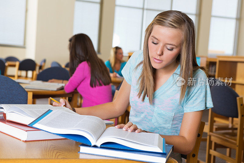 勤奋的高中女生在图书馆看书