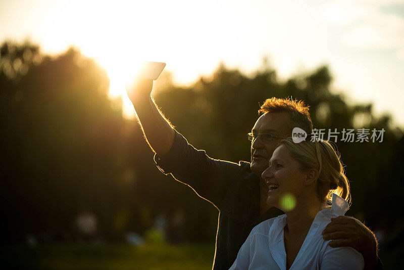 一对情侣在夕阳下自拍