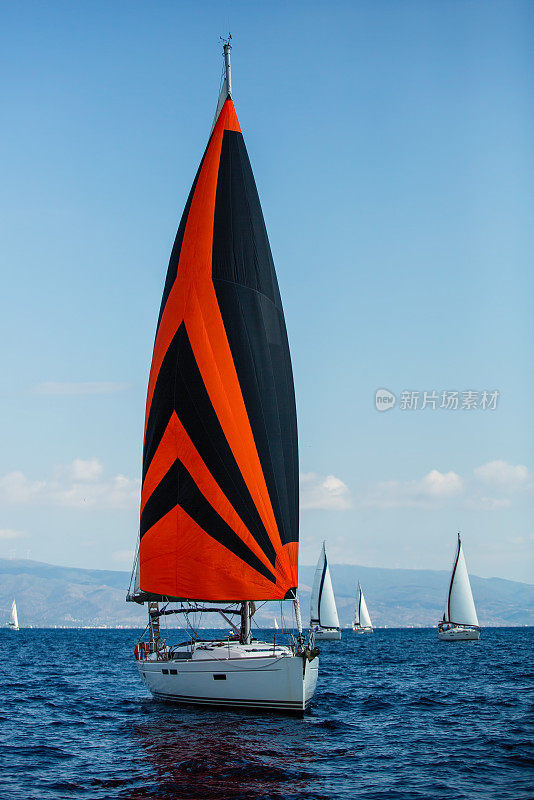 爱琴海希腊海岸，帆船在色彩鲜艳的船帆下参加帆船赛。