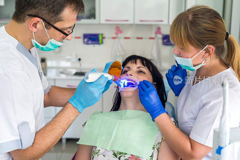 牙医和护士与病人在牙科工作