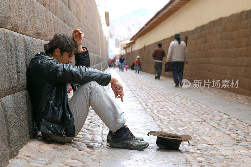 一个乞丐坐在印加城墙附近