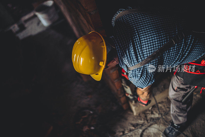 在建筑工地上用钻头工作的人