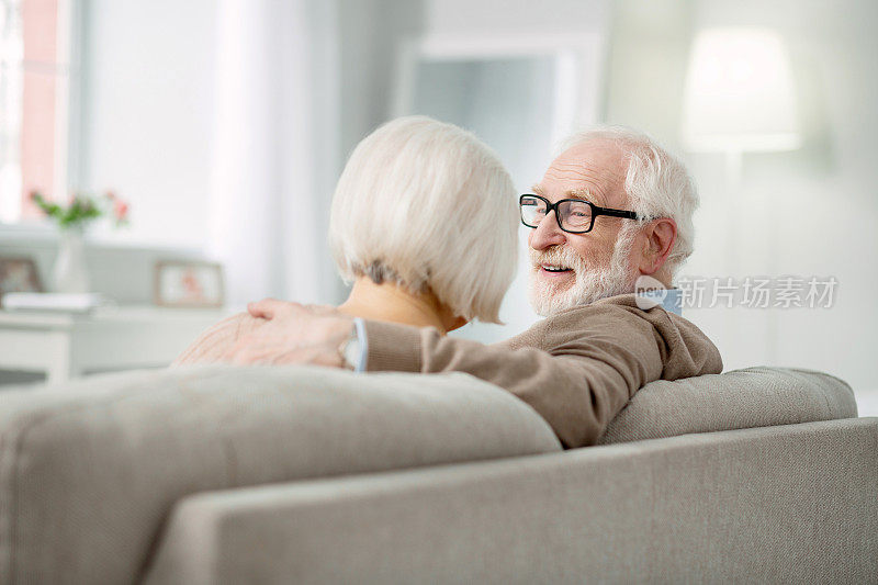 一对幸福的老夫妇坐在沙发上