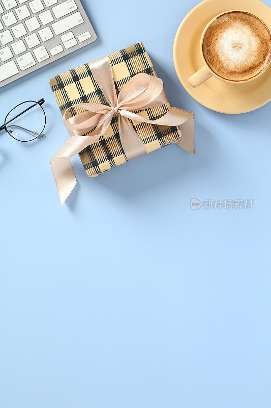 父亲节快乐垂直横幅模板。平铺老式礼盒与丝带蝴蝶结，键盘，眼镜，咖啡杯在蓝色的背景。