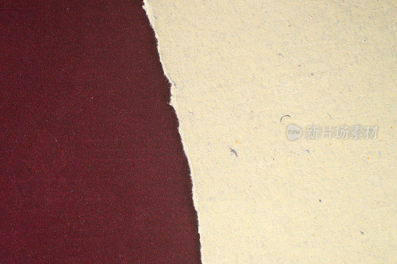 水平空对比将背景分成两半，撕裂黑巧克力棕色的grunge纹理纸的纹理和皱纹，显示出一个简单的淡奶油色或米色层