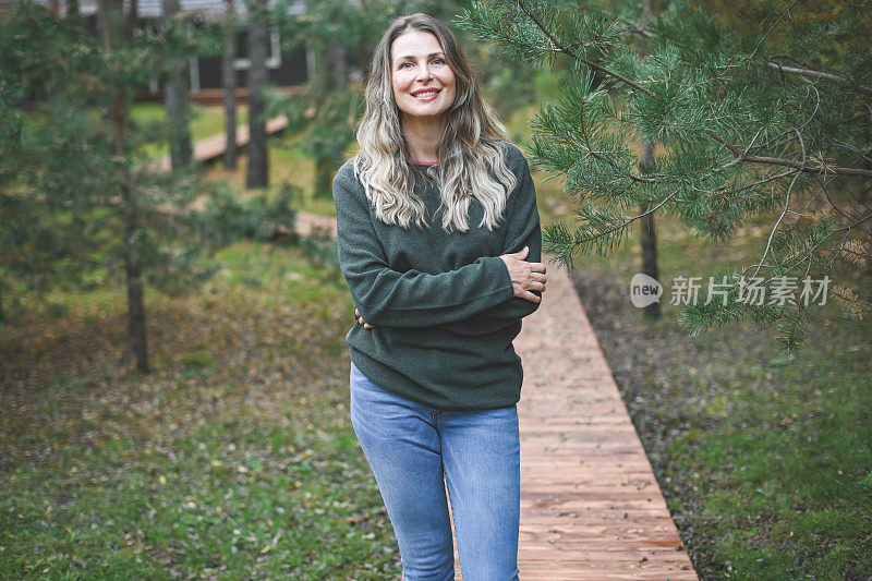 美丽的女人走在她的小花园里