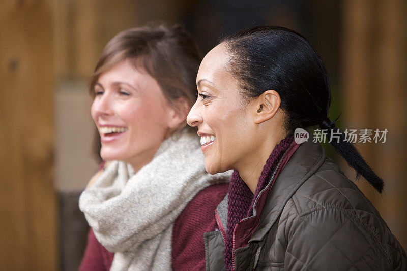 两个女人在咖啡馆里和坐在对面看不见的人聊天