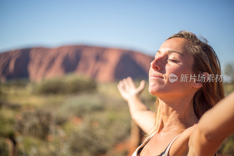 年轻女子张开双臂，渴望自由和积极的情绪