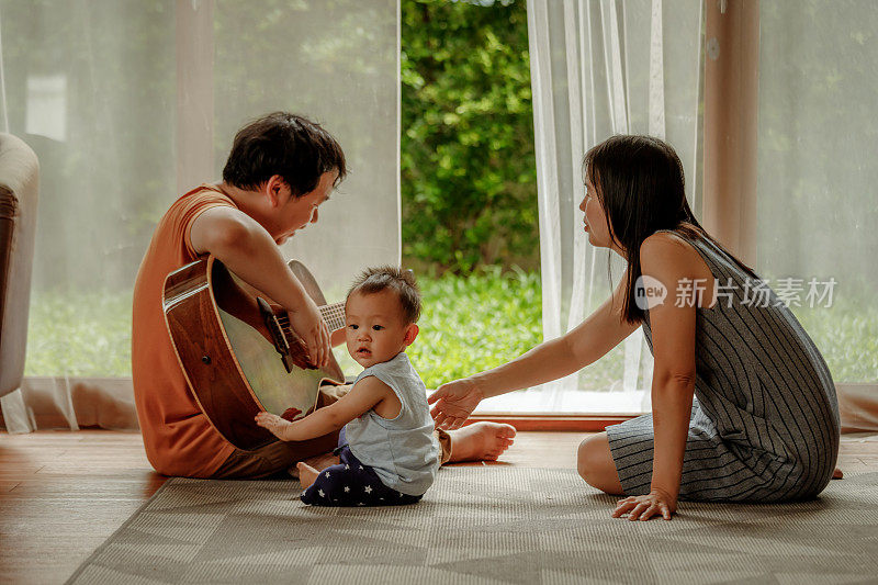 亚洲家庭在客厅里做活动。幸福家庭家庭生活理念。