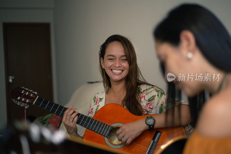 女人唱歌，弹吉他。