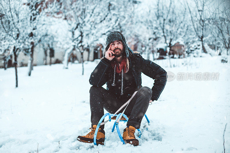 在滑雪胜地滑雪橇的英俊男子