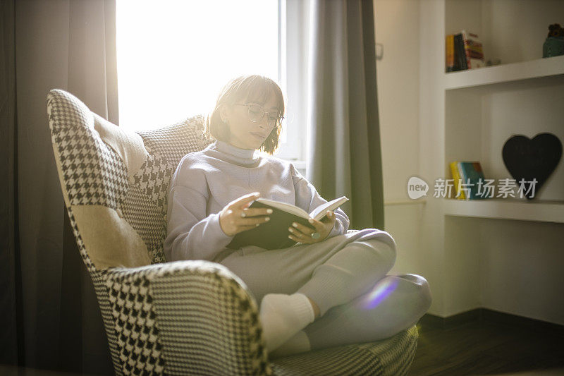 爱幻想的女孩在家里读书享受