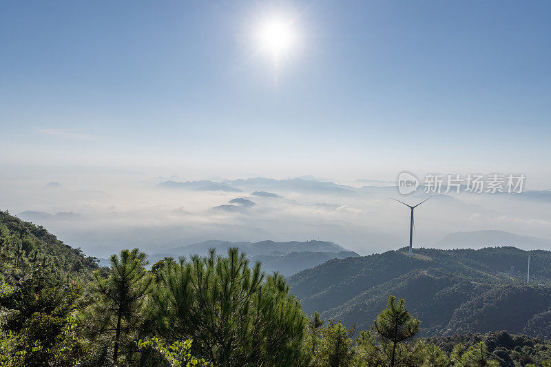 云海和阳光普照的山峰上的风力