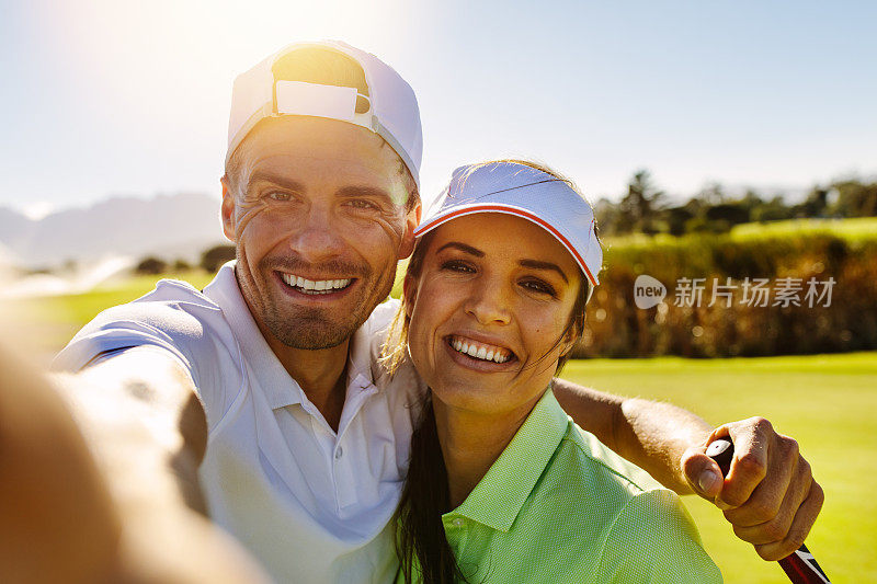 一对快乐的年轻情侣在高尔夫球场自拍