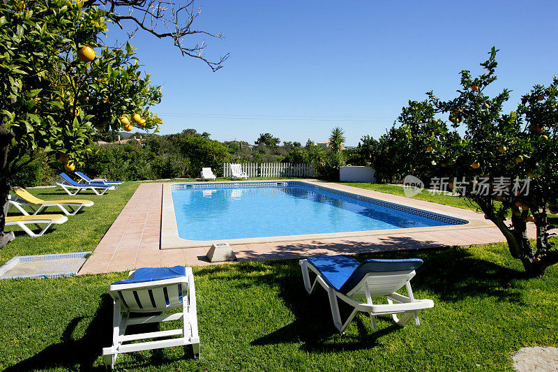 度假别墅游泳池与太阳躺椅
