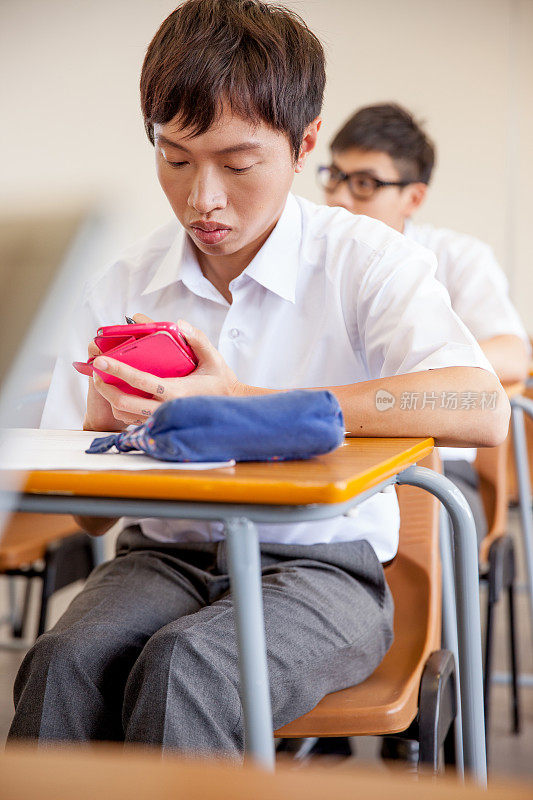 学生在教室里使用智能手机