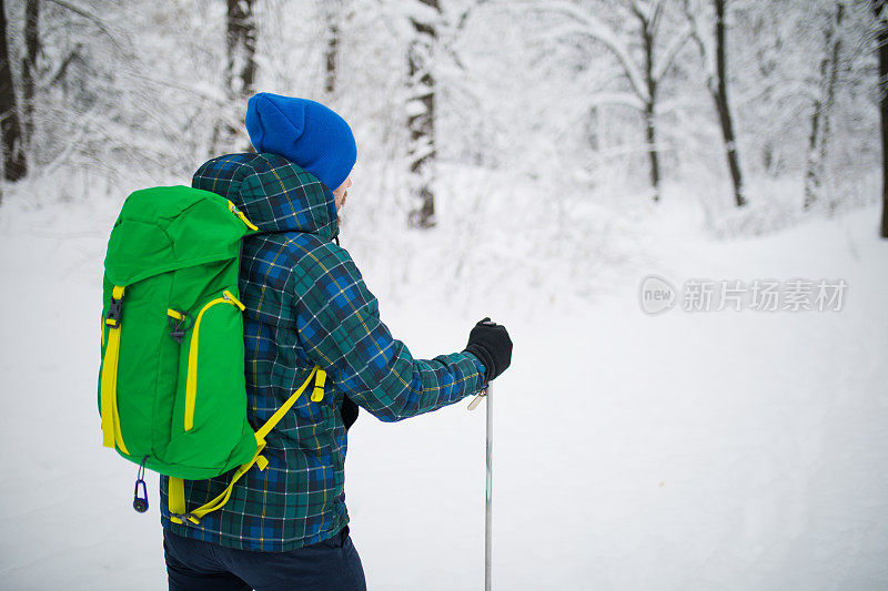 年轻人后视图独自行走雪山的旅行者。