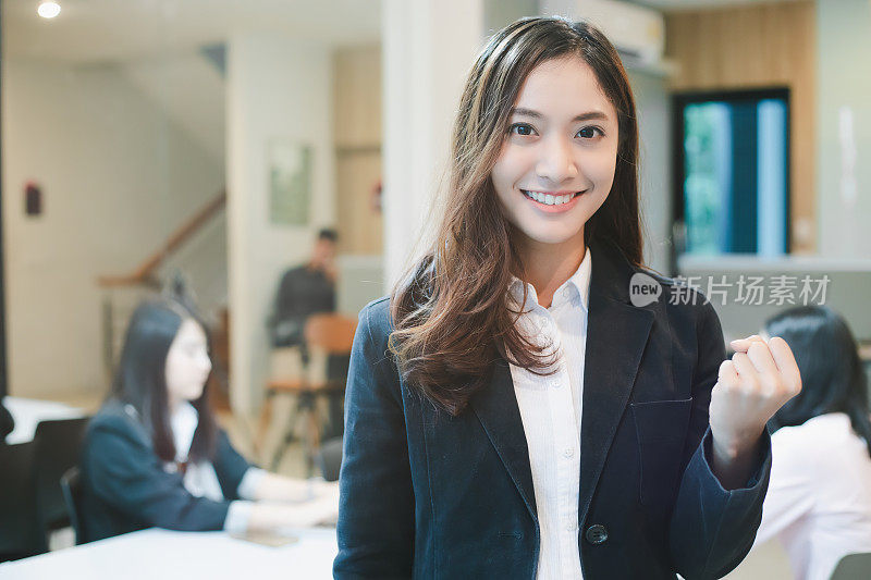 亚洲商界女性成功与取胜理念——快乐团队举起双手庆祝突破与成就