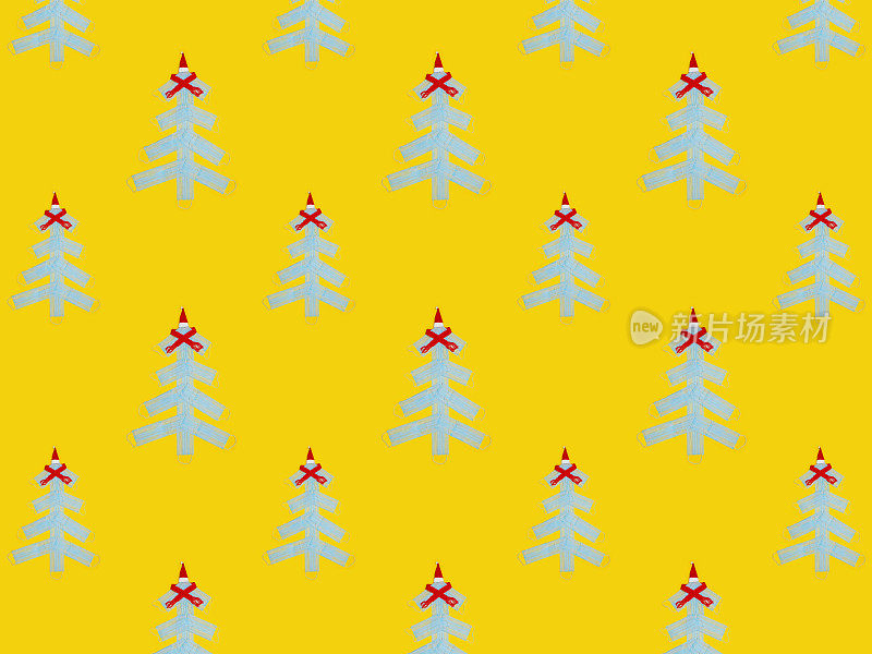 用黄色纸做背景的医用口罩制成的圣诞树。圣诞节无缝模式