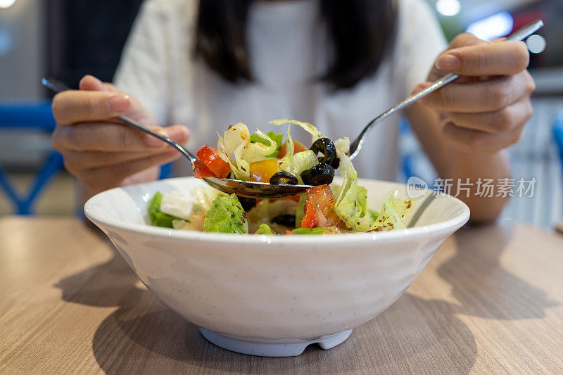 亚洲妇女在素食咖啡馆吃素食午餐