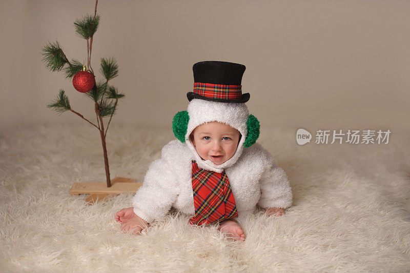 可爱的婴儿在雪人服装