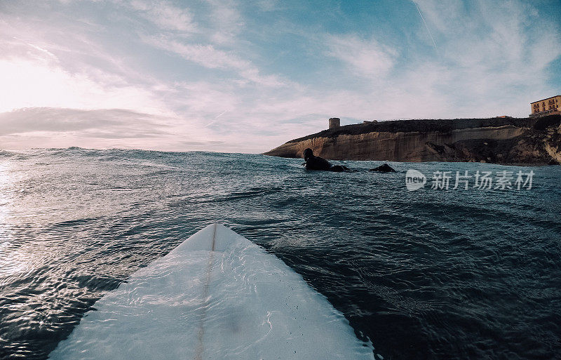 冲浪者划过悬崖和灯塔