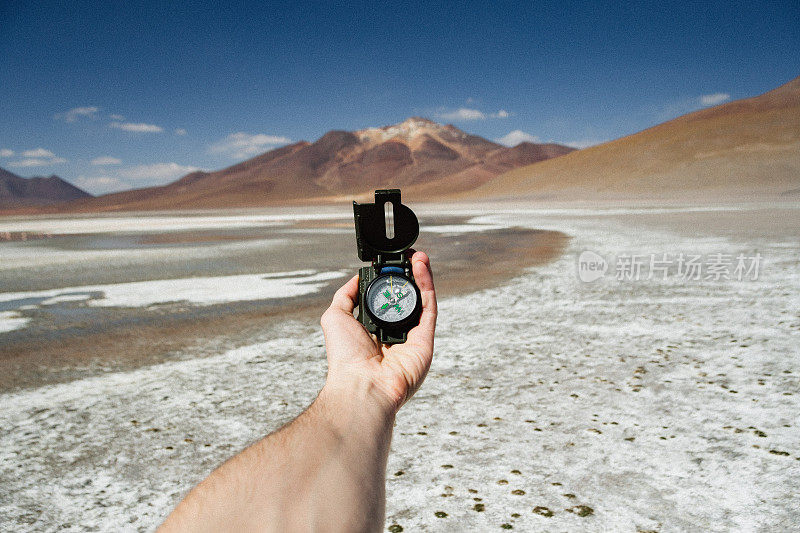 一个手里拿着指南针的人在玻利维亚的Altiplano