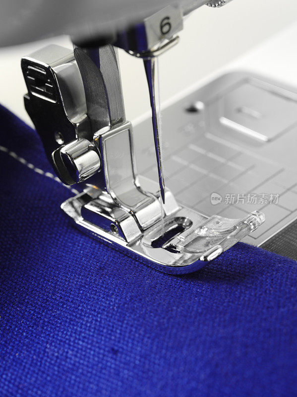 缝纫机针在蓝色织物上