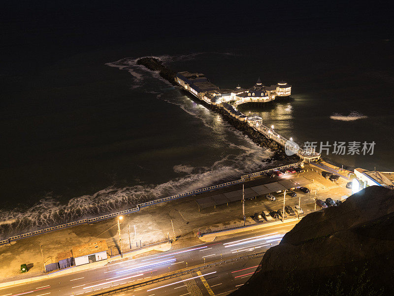 照亮了秘鲁利马的夜间海洋码头和海岸公路
