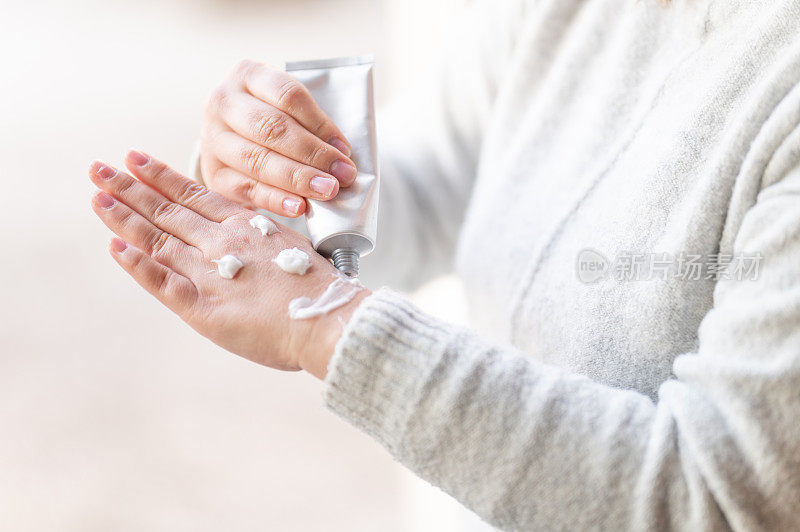 女人用护手霜在手上画笑脸