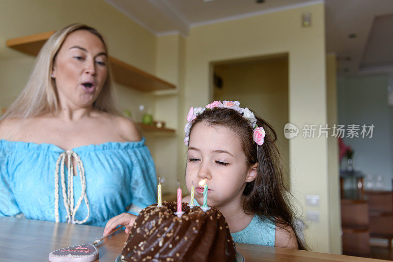 女孩吹灭了生日蛋糕上的蜡烛