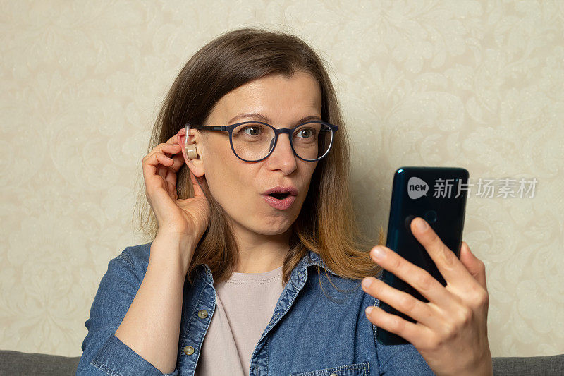 一名使用助听器的妇女通过智能手机网络摄像头说话。