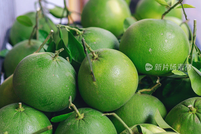 新鲜的绿色柚子柑橘类水果在市场摊位出售