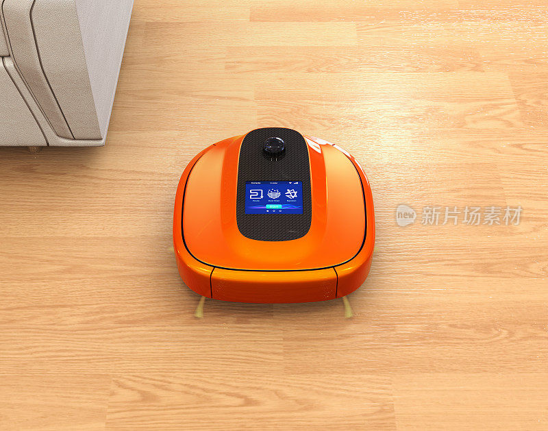 地板上的金属橙色机器人吸尘器