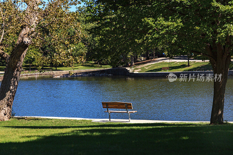 公园长椅旁有一个安静的池塘