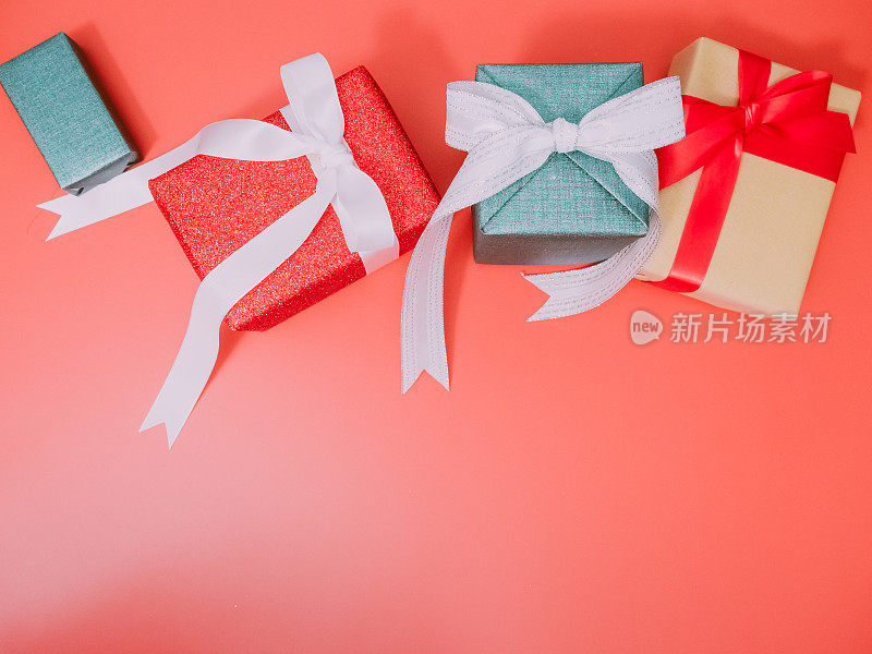 为庆祝圣诞节、生日或新年，以红色为背景，用闪亮的包装纸包装成色彩缤纷的礼品盒