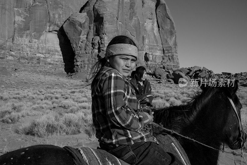 一个年轻的印第安男孩，骑着他的马，黑白的形象