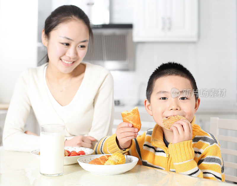 母亲喂孩子吃早餐