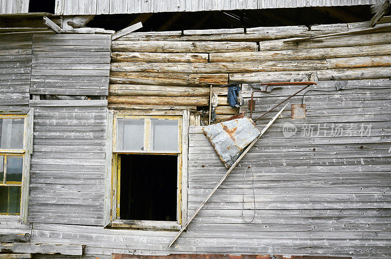 老旧的废原木木板住宅，碎墙玻璃