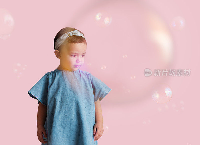 小女孩在观察泡泡是如何落下的
