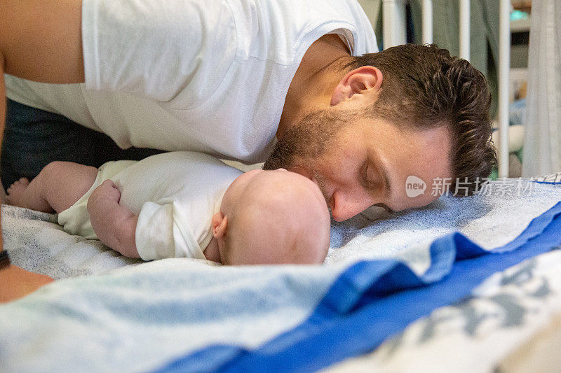 爱:父亲在给他的宝贝换完尿布后亲吻他
