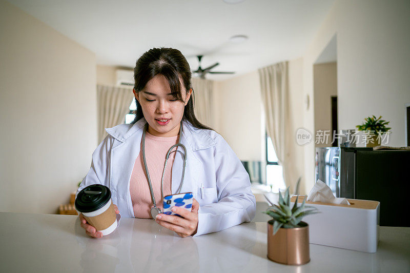 一名女医生拿着一杯咖啡，一边用手机