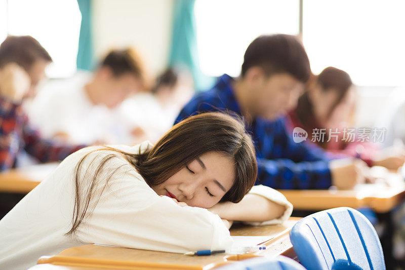 疲惫和睡着的大学生在教室考试