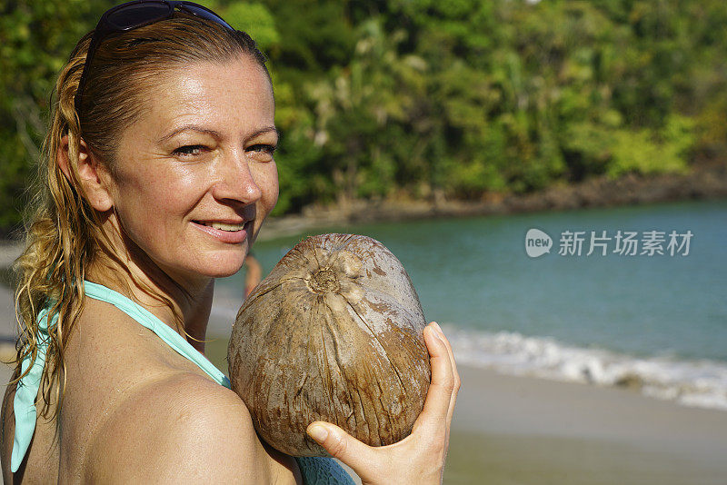 巴拿马曼努埃尔·安东尼奥国家公园的曼努埃尔·安东尼奥海滩上的女人和椰子的肖像